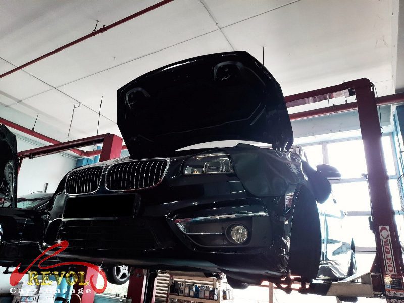 The worn front shock absorber on the BMW 216i, weeping and weak.