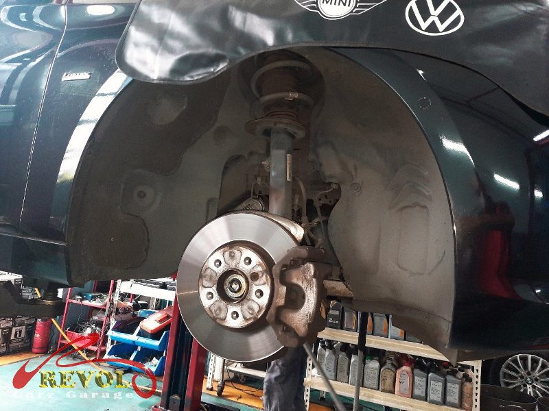 Both old front struts removed and lined up against the new pair.