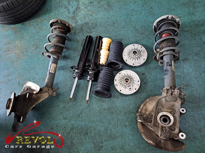 The new BMW-spec front struts and top mounts ready to fit.