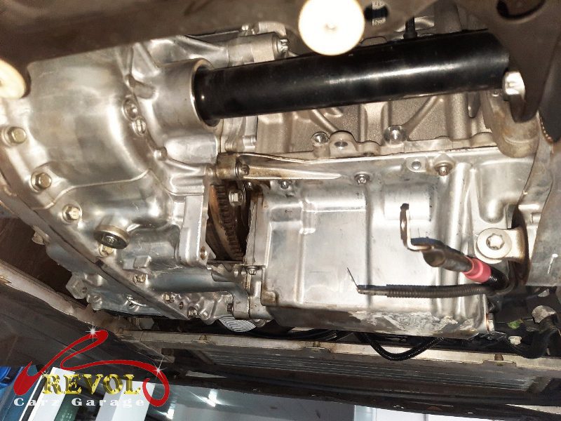 The old worn starter motor removed from the engine.