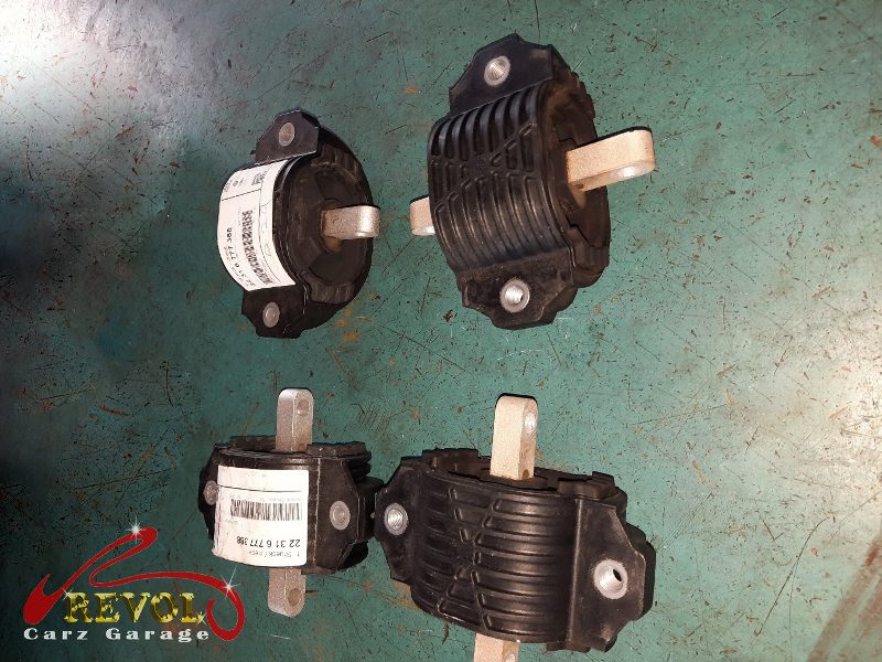 The worn gearbox mount with cracked rubber removed.