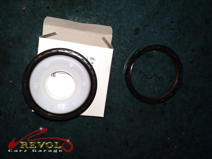 The flywheel between the torque converter and the gearbox, the leaking seal exposed.