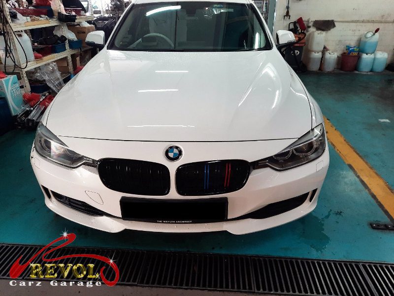 BMW 320i parked at the workshop, in for battery and tail light bulb replacement.