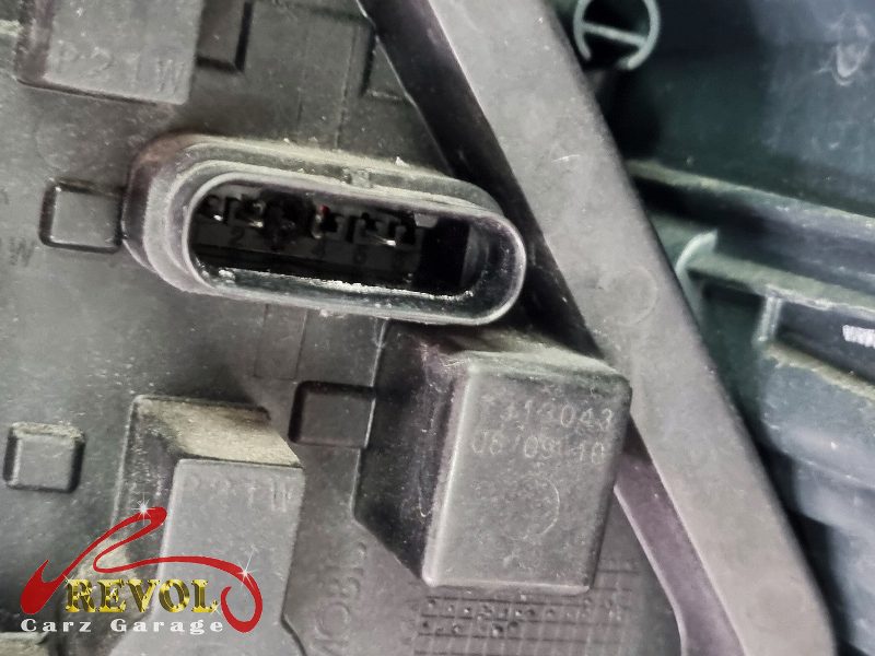 The blown tail light bulb removed from its holder.