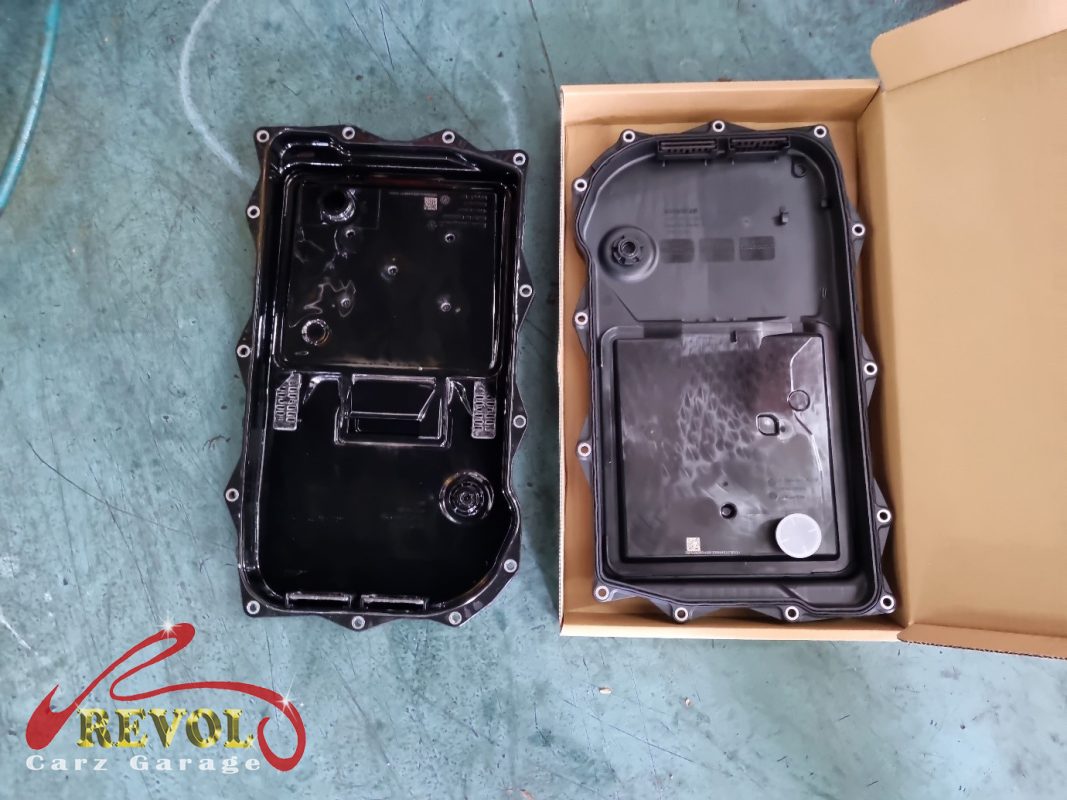 The old transmission pan dropped showing the pan-and-filter assembly.