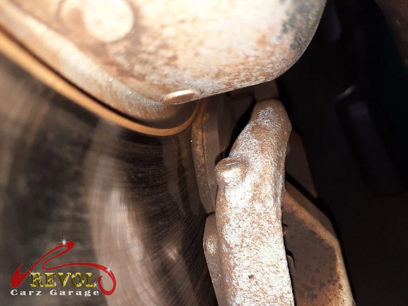 The old front discs removed alongside the new genuine set.
