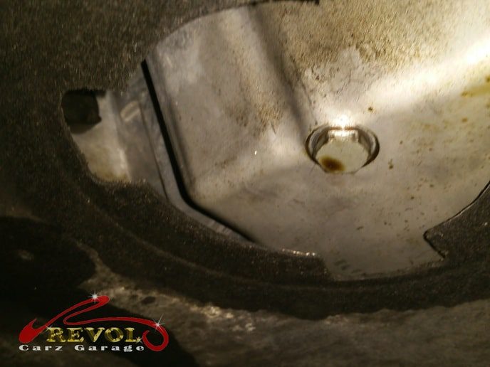 The BMW 535i hoisted, the oil leak traced to the sump.