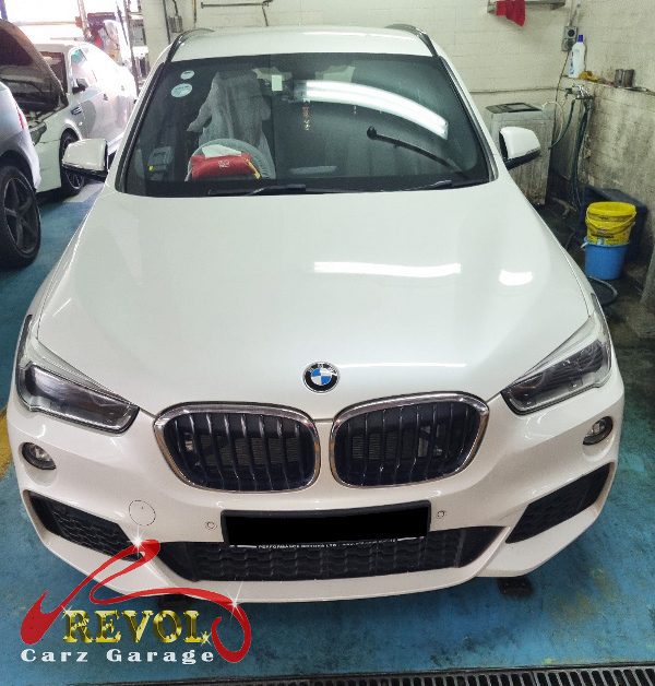 BMW X1 parked at the workshop, in for front brake inspection.