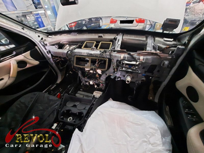 The dashboard removed to reach the heater-and-aircon box.