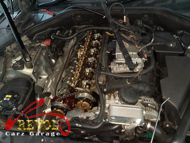 The old warped plastic valve cover removed from the cylinder head.