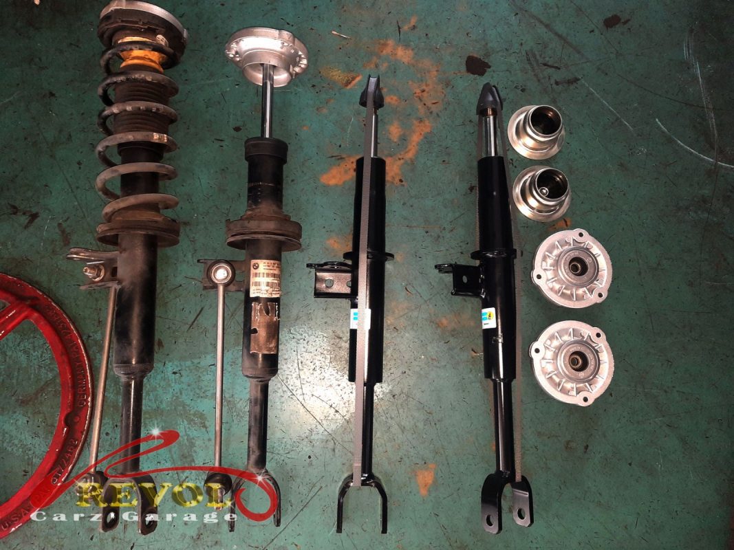 Both old front struts removed alongside the new pair.