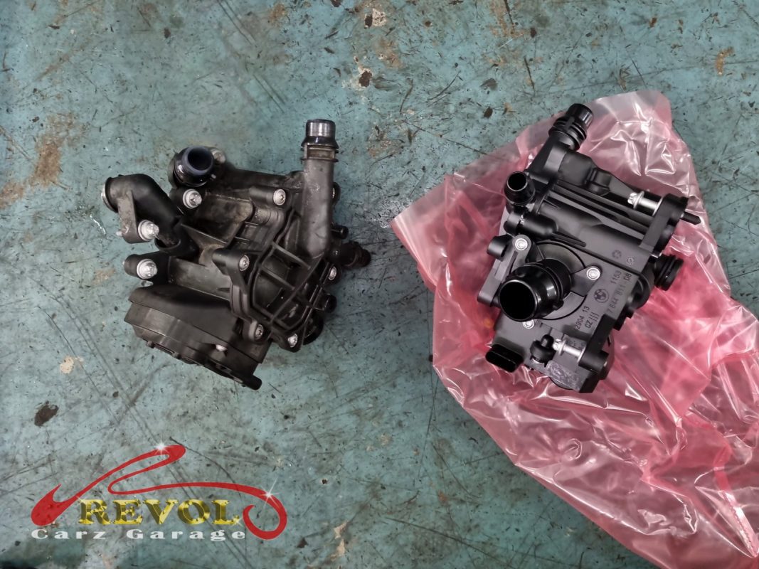 The old water pump removed showing the weeping seal and rough bearing.