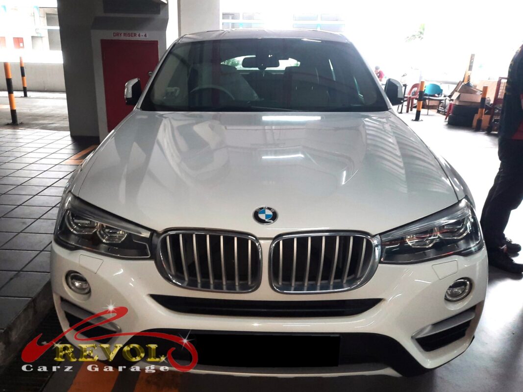 BMW X4 parked at the workshop, in for valve cover oil leak inspection.