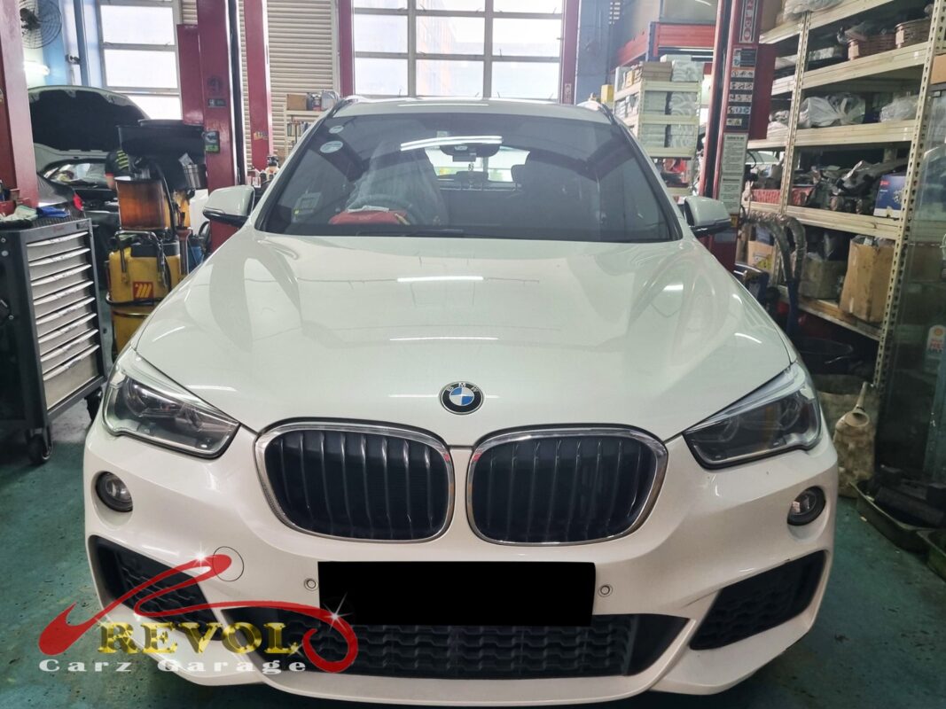 BMW X1 parked at the workshop, in for rear shock absorber inspection.