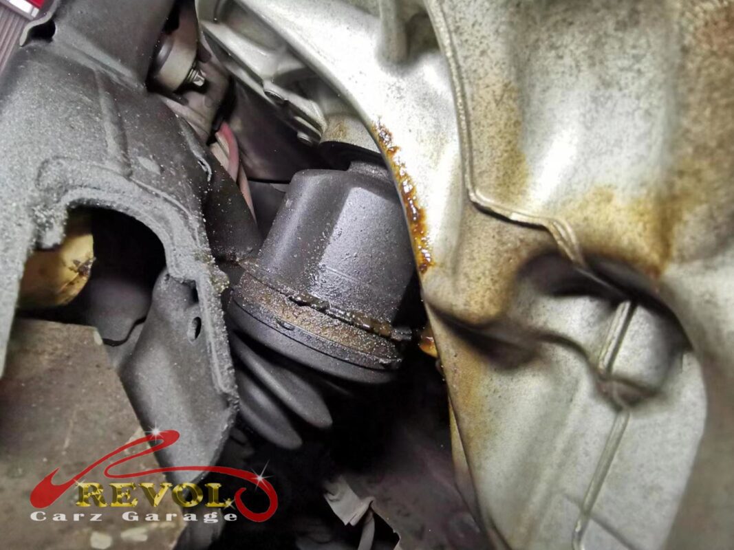 The split driveshaft boot and grease on the undercarriage of the BMW 216d.