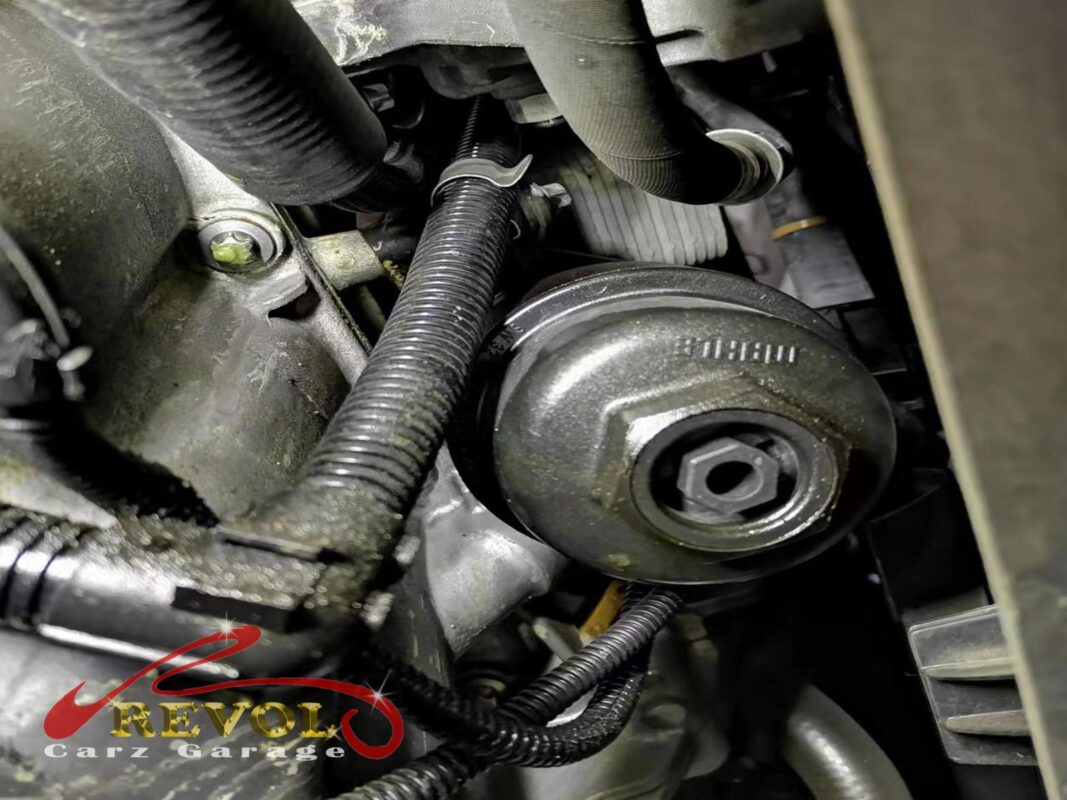 The oil filter housing removed and the old hardened gasket exposed.