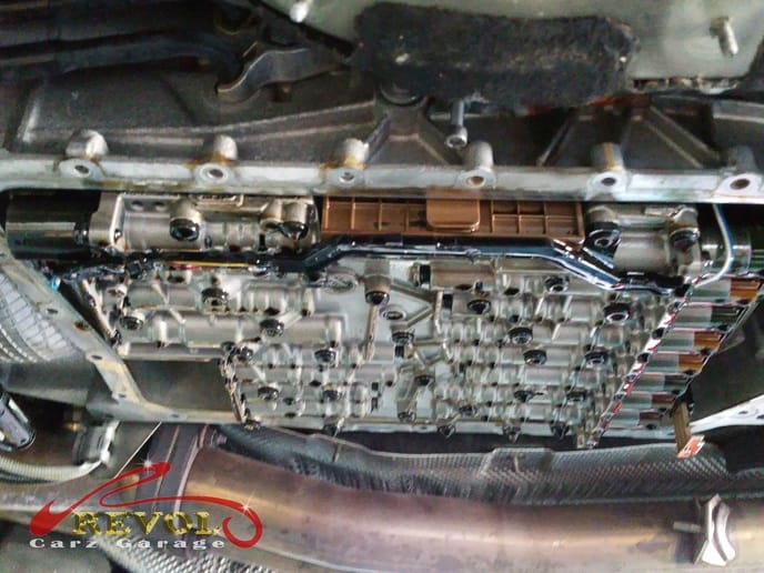 The mechatronic replacement underway, the transmission pan off.