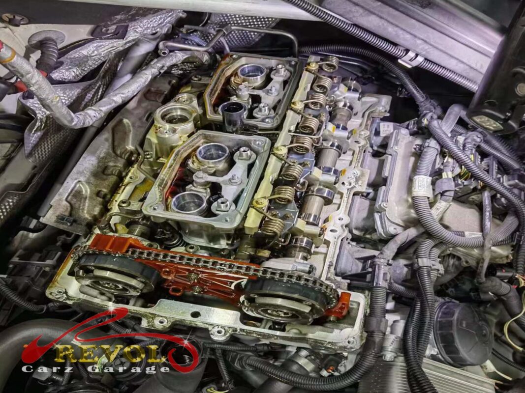 The old warped valve cover removed from the engine.