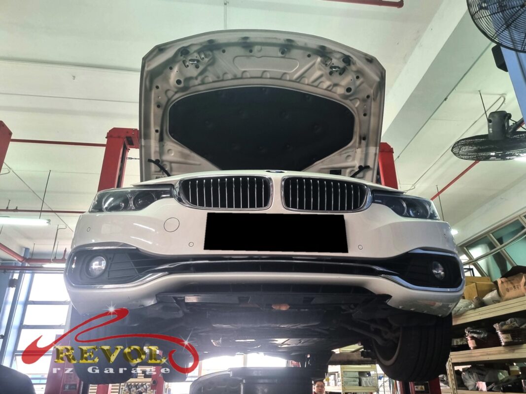 The BMW 420i up on the two-post lift, in for its routine maintenance interval.
