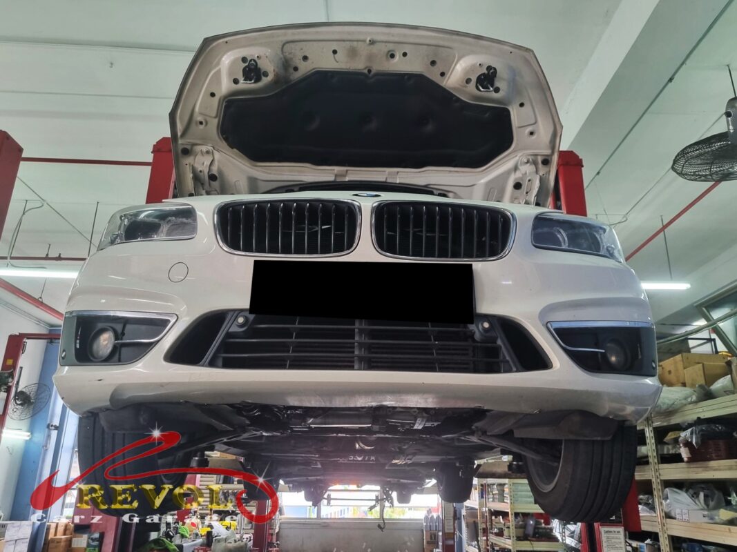 The BMW 216d up on the two-post lift, in for the cooling system job.
