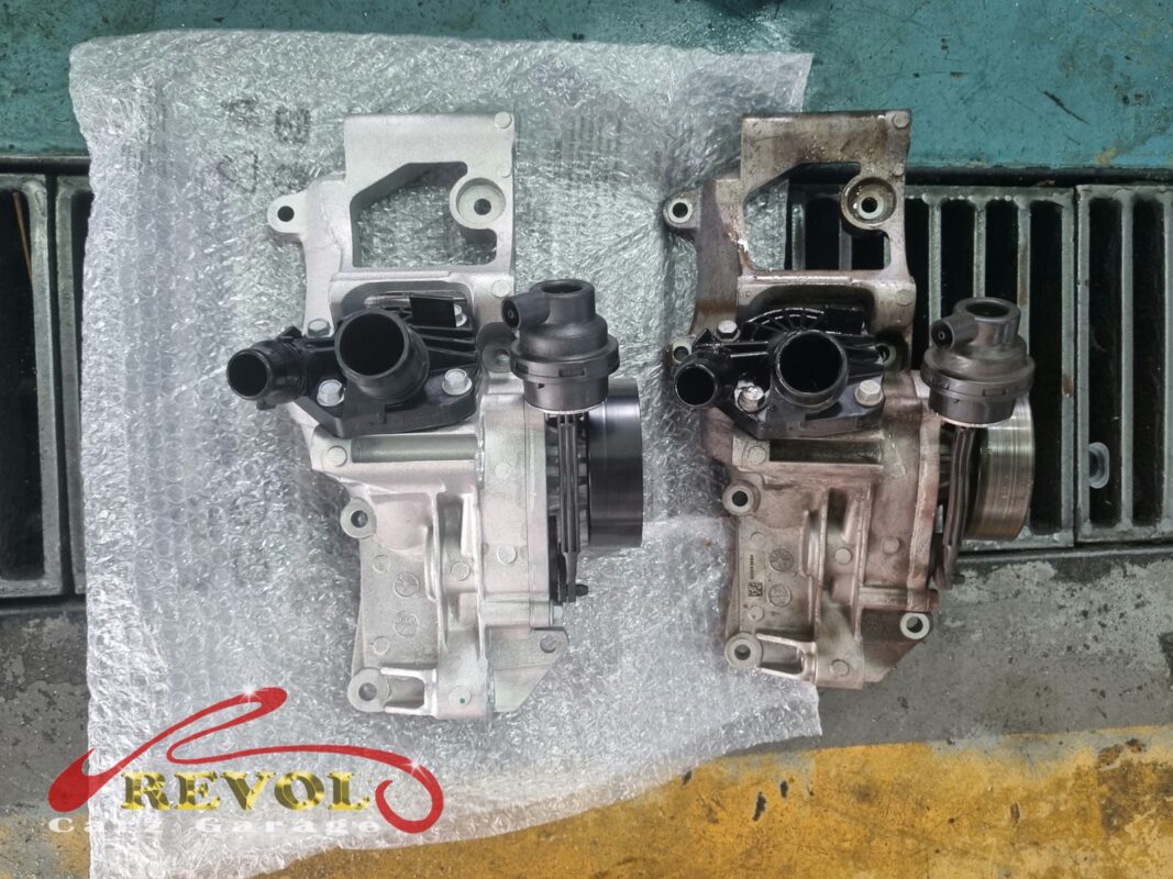 The new BMW-spec water pump housing (left) next to the old one (right, grimy and weeping at the seal).
