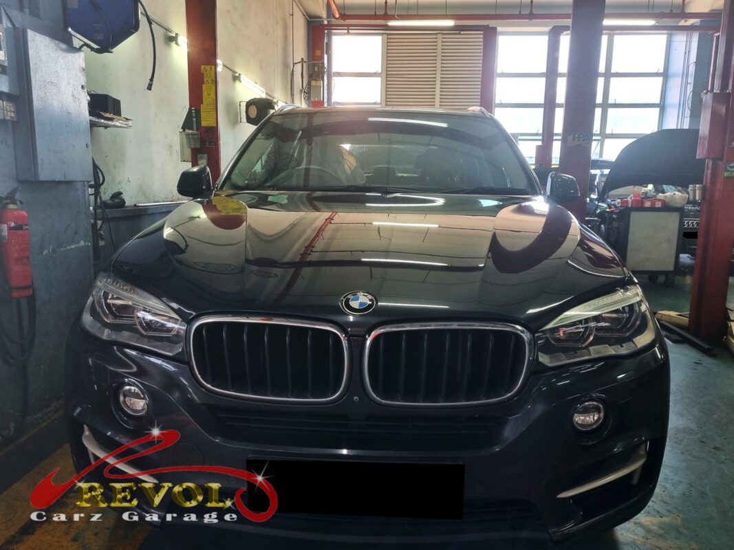 BMW X5 on the lift for front brake pad and sensor replacement.
