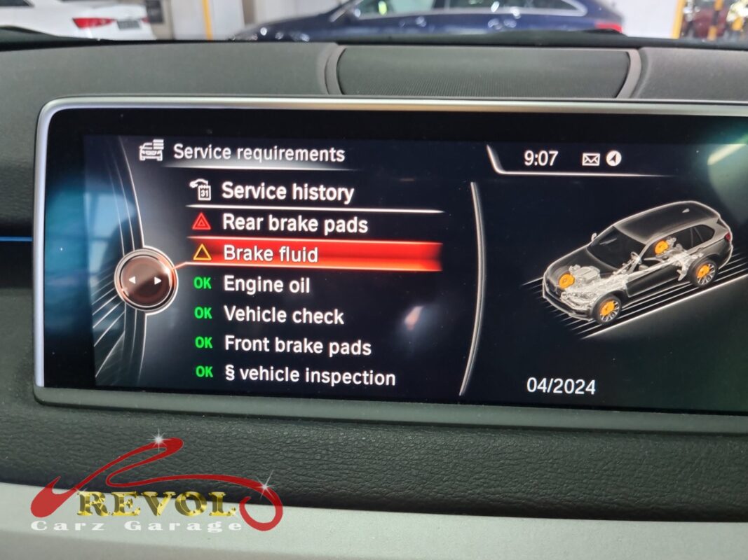 The car's own service screen had it: 'Rear brake pads' flagged red and 'Brake fluid' flagged, with the front pads still showing OK.