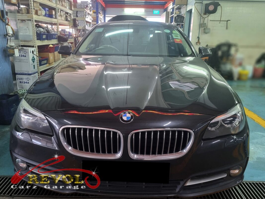 BMW 520i with the front bumper off for radiator replacement.