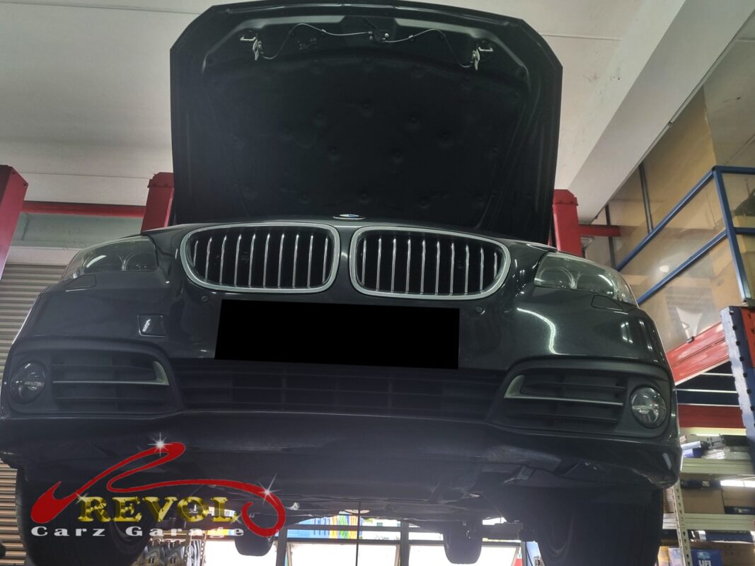 The BMW 520i up on the two-post lift, in for the cooling system job.
