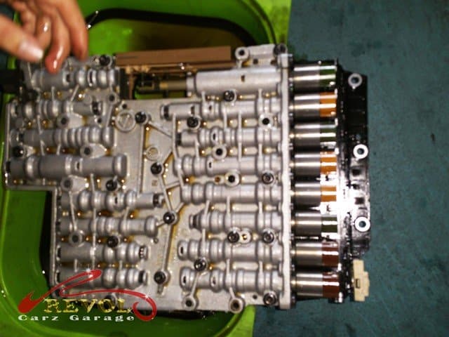 The car lifted to access the mechatronic unit in the transmission box.