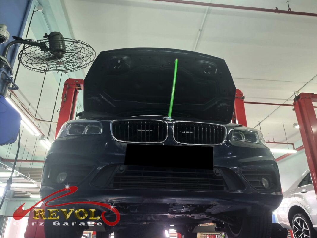 The BMW 216d up on the two-post lift, in for the cooling system job.