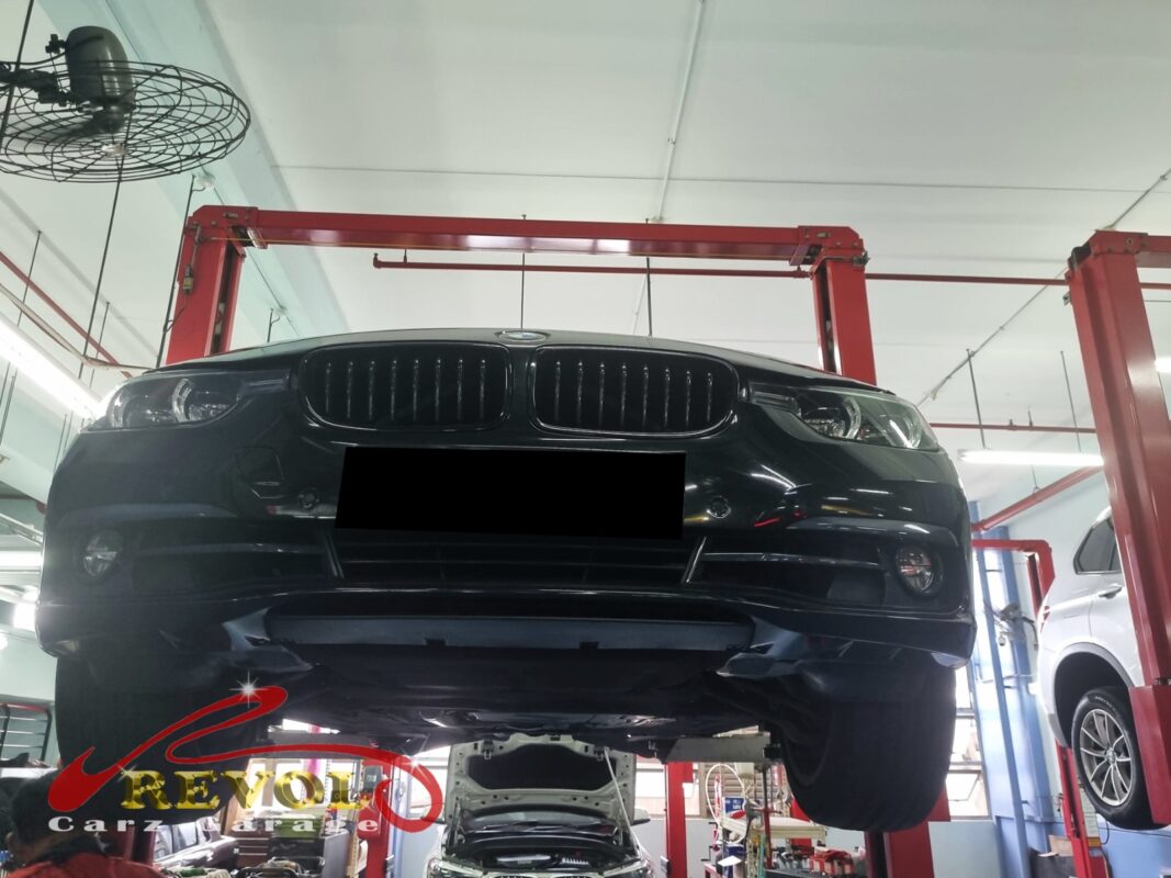 The BMW 320i up on the two-post lift, in for the rear suspension work.