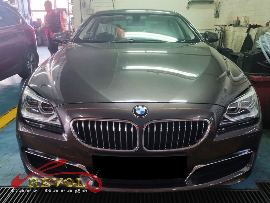BMW 640i with the engine bay open for coolant pump replacement.
