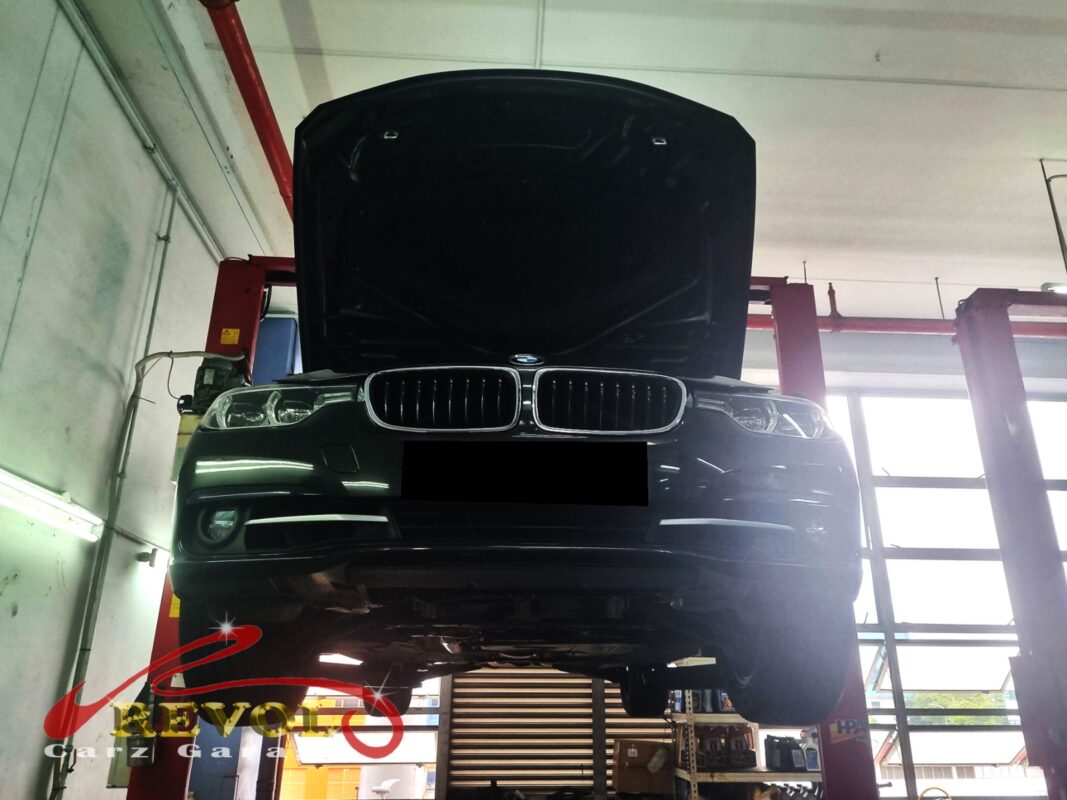 The BMW 318i up on the two-post lift, in for the front suspension work.