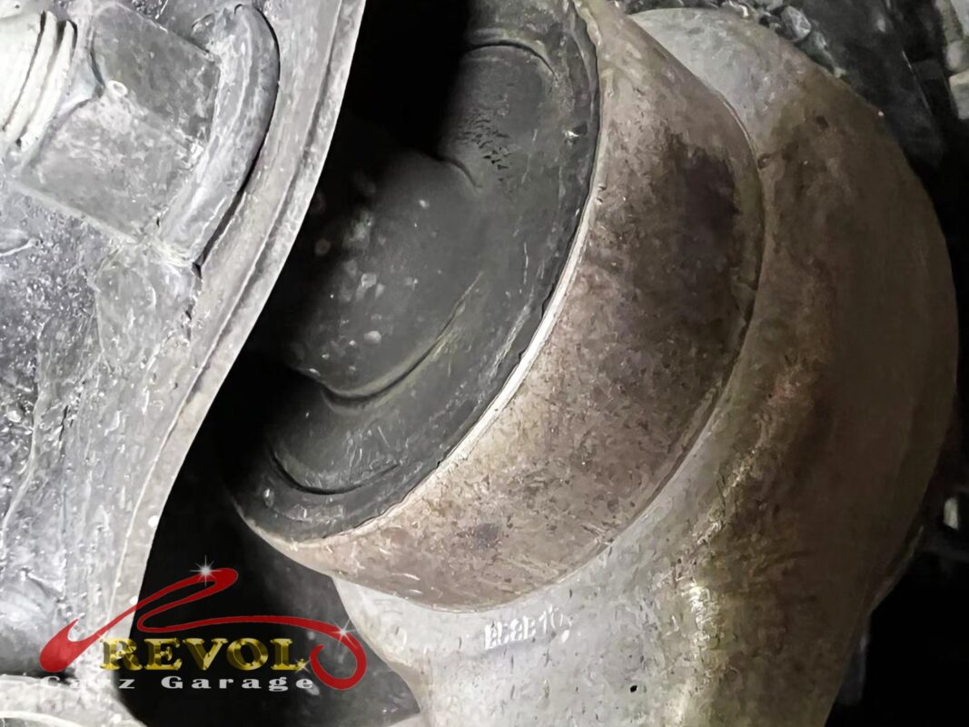 A control-arm bushing on the car, the rubber aged and cracking, well past service spec.