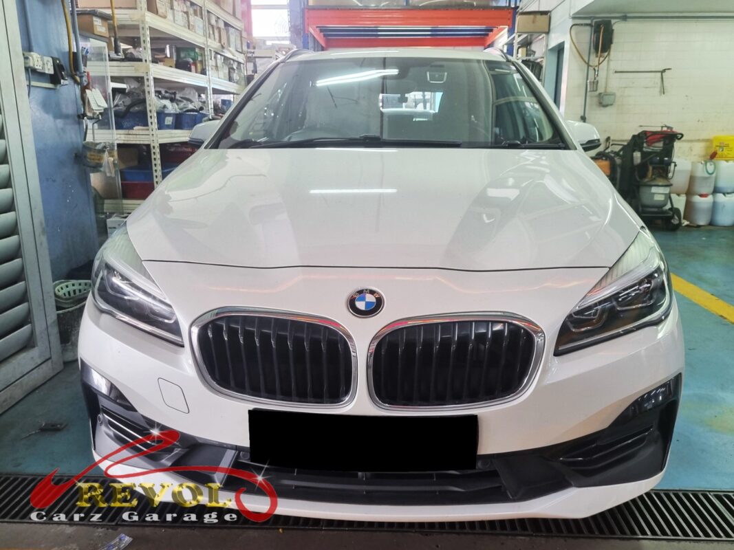BMW 216i with the engine bay open for turbocharger replacement.