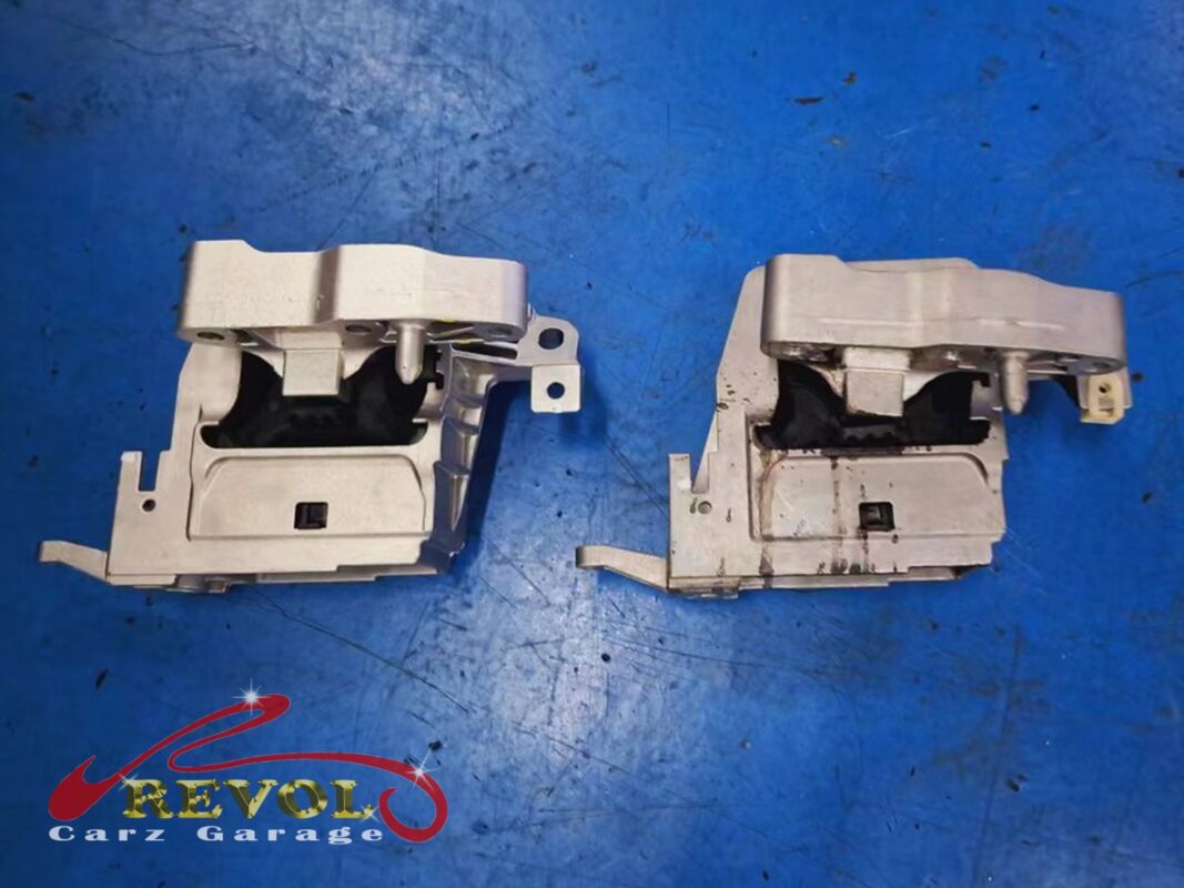 Two of the old mounts off the car, the rubber sections collapsed and one of them soaked in oil.