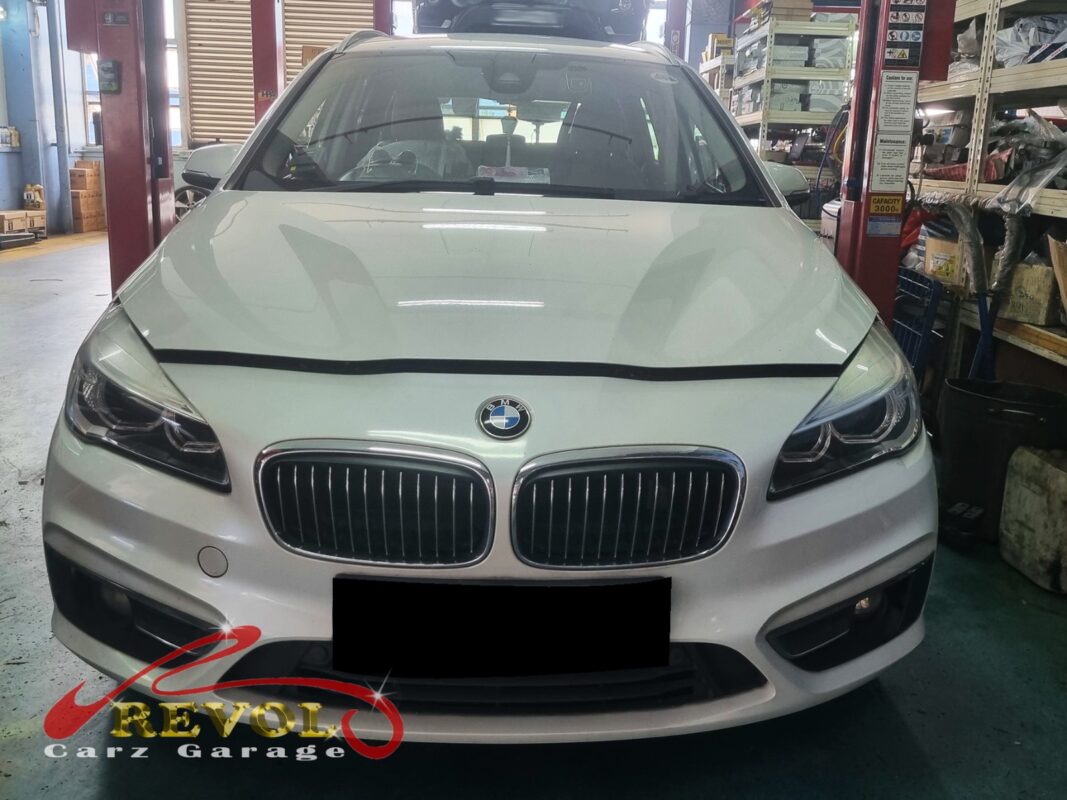 BMW 216i on the workshop lift for front absorber linkage replacement.