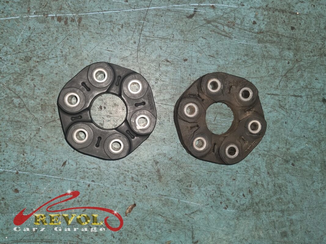The old propshaft flex disc (right), cracked and out of shape, next to the new BMW-spec replacement (left).