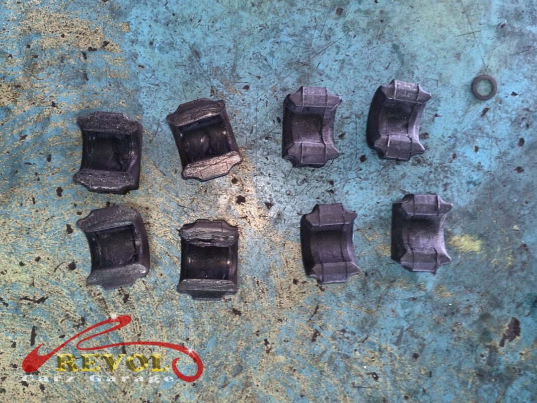 The old anti-roll bar bushes (left), deformed and worn, beside the new BMW-spec set (right), front and rear.