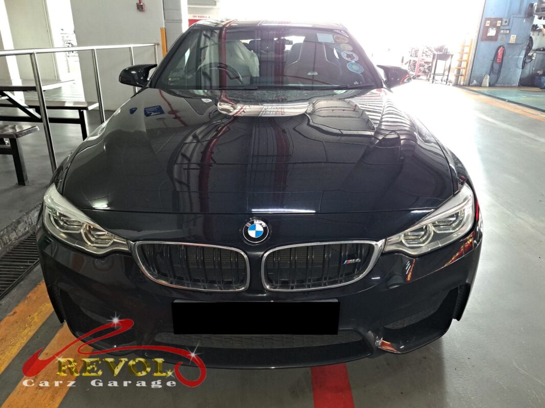 BMW M4 on the workshop lift for front absorber linkage replacement.