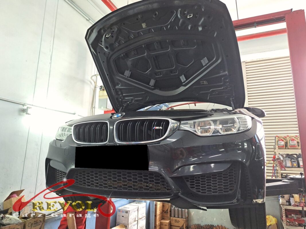The M4 up on the two-post lift, in for the front linkage job.