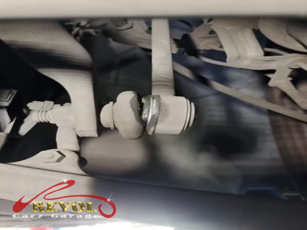 One of the front anti-roll bar drop links still on the car, bolted to the bar, the ball joint worn loose.