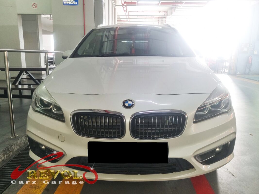 BMW 216d with the engine cover off for timing pulley and belt diagnosis.