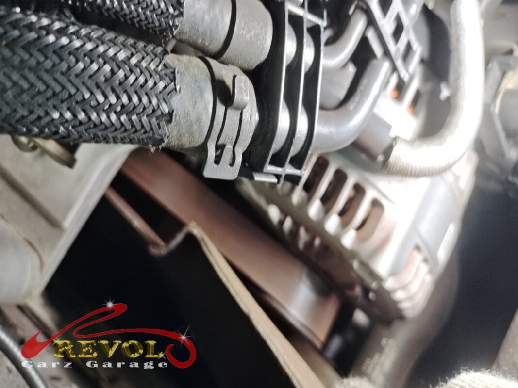 The front of the 216d's engine where the rattle was coming from, the accessory belt drive tucked in behind the fuel lines and alternator.