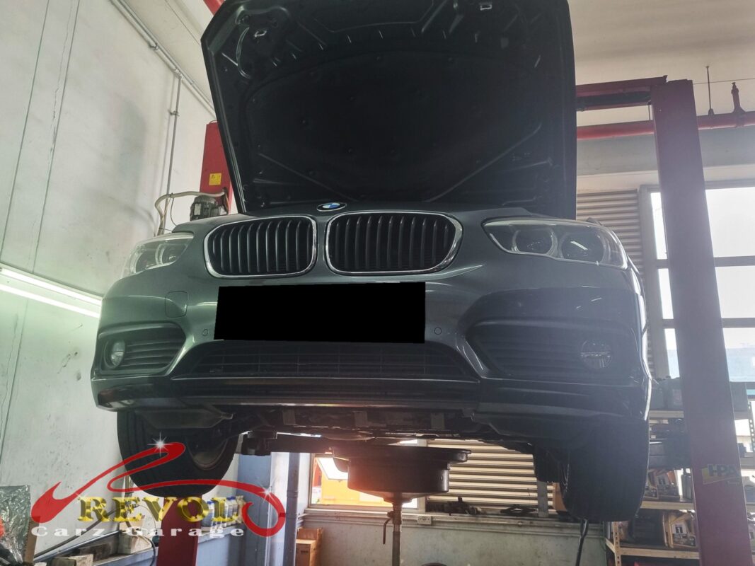 The 116d up on the two-post lift, in for the rear shocks.