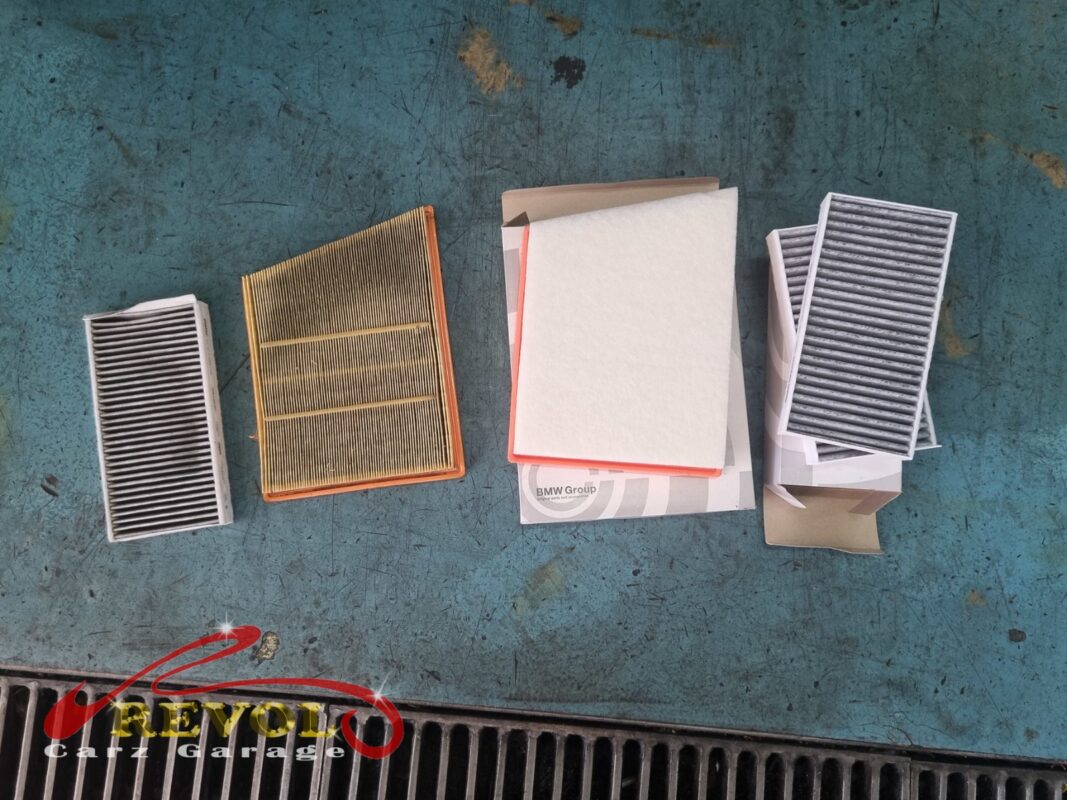 The old air and cabin filters out, the new BMW-spec engine air filter and cabin filters ready to go in.