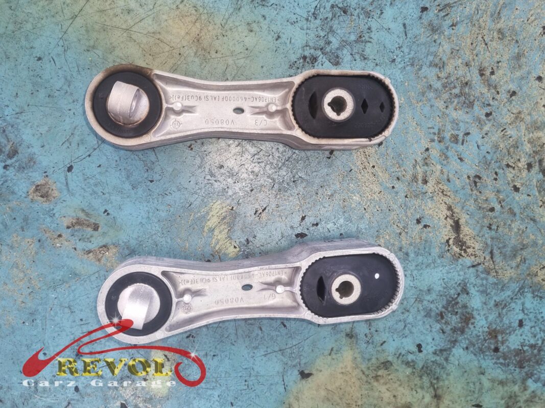 The lower torque strut, the worn one (top) beside its new BMW-spec replacement (bottom), the third piece of the set.