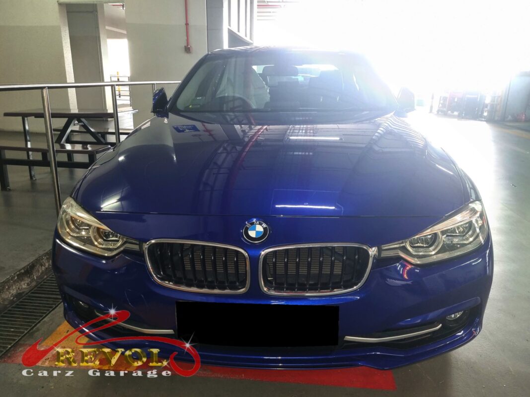 BMW 318i on the workshop lift for routine scheduled servicing.