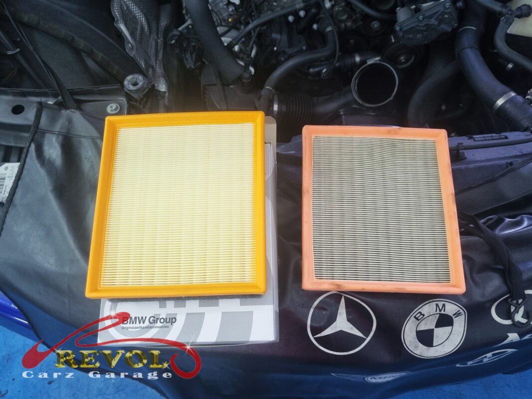 The clogged old engine air filter (right) next to the new BMW-spec replacement (left).